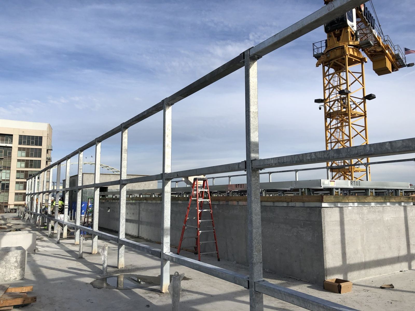 Perimeter steel framing with tower crane on a commercial jobsite